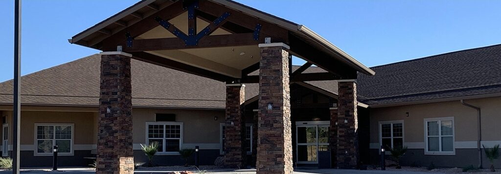 The front of a building with a stone covered entrance.