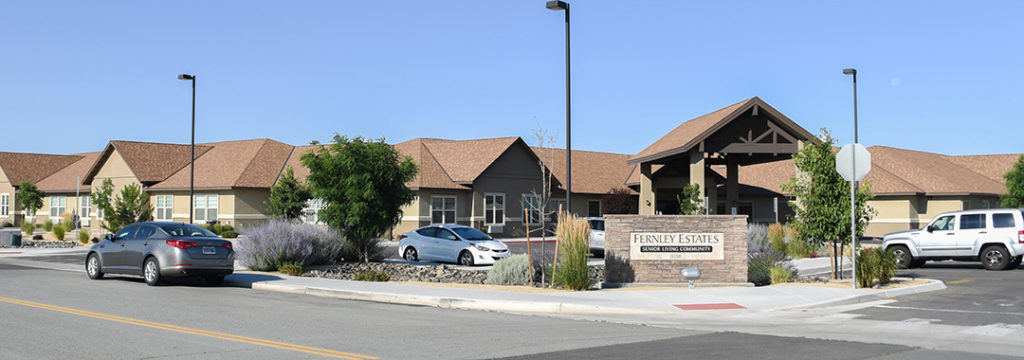 A car park in front of a building with a sign that reads Fernley Estates.